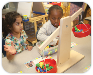 2 children using a balance scale